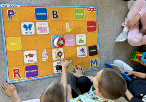 Uczniowie programują robota Doc według wskazówek z kart pracy.