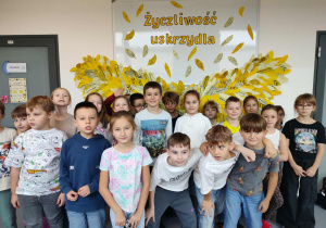 uczniowie klasy 2a pozują na tle dekoracji – skrzydeł życzliwości