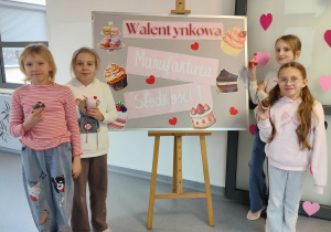 dziewczynki ze słodkościami pozują na tle dekoracji