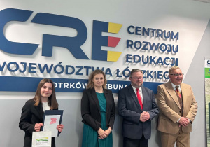 Wspólne zdjęcie uczennicy z osobami wręczającymi nagrodę